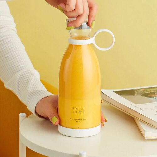A hand holding a white Fresh Juice blender filled with yellow juice on a yellow background.