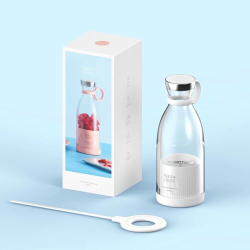 A Fresh Juice White transportable blender, a charger for the blender which is also white in color, the FreshJuice blender box white in color with a blue side showing the image of a pink colored blender filled with raspberries, all in front of a blue background.